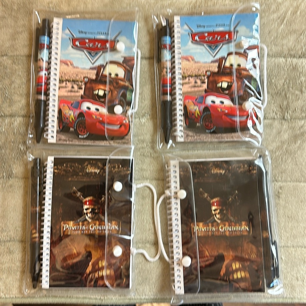 4 Small Disney Cars and Pirates of the Caribbean Notebook with matching pens.